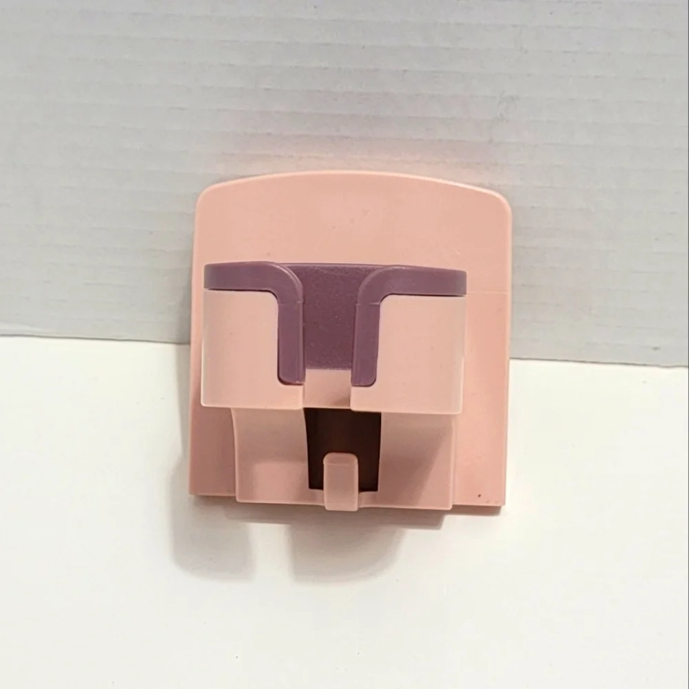 Pink and Purple Wall-Mounted Blow Dryer Holder.